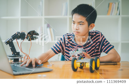 Asian boy learning and studying the work of technology robots.homeschool and science for tech project. playing childhood kids hobby leisure lifestyle people toys robotics technology. Asian boy learning and studying the work of technology robots.homeschool and science for tech project. playing childhood kids hobby leisure lifestyle people toys robotics technology. 111369409