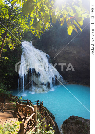 Ko Luang Waterfall is a limestone waterfall in northern Thailand..Calcium carbonate and magnesium occur naturally in Koh luang Fall. The waters get their blue color from the magnesium. Ko Luang Waterfall is a limestone waterfall in northern Thailand..Calcium carbonate and magnesium occur naturally in Koh luang Fall. The waters get their blue color from the magnesium. 111369462