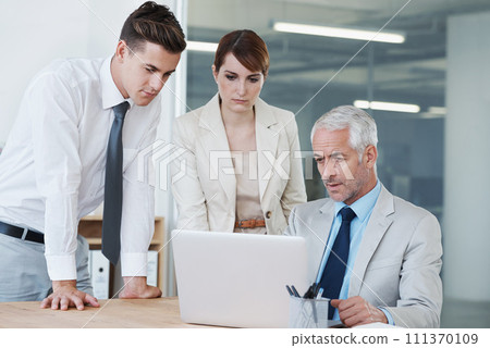 Business people, laptop and discussion on proposal in boardroom, communication and meeting in office. Senior manager, employees and technology for assistance in training, mentor and advice for work 111370109