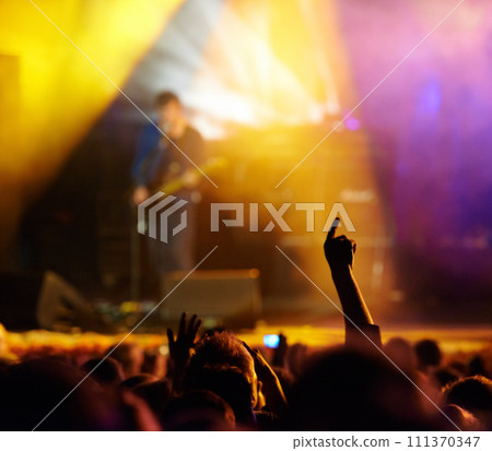 Concert, audience and hands in crowd with band for music festival, night club and dancing with light. Disco, party and people with signs, gesture or performance at rock event with stage entertainment 111370347