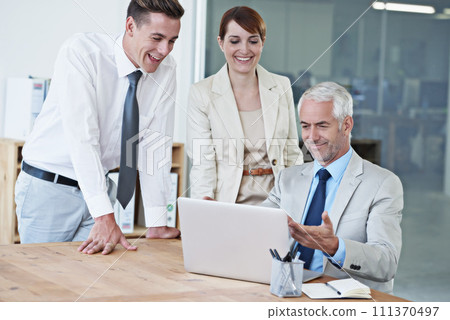 Business people, laptop and happy discussion in boardroom, communication and meeting in office. Senior manager, employees and technology for assistance in training, mentor and advice for support 111370497