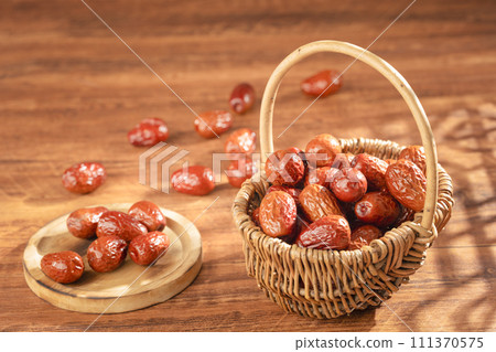 Dates in basket on wooden table 111370575