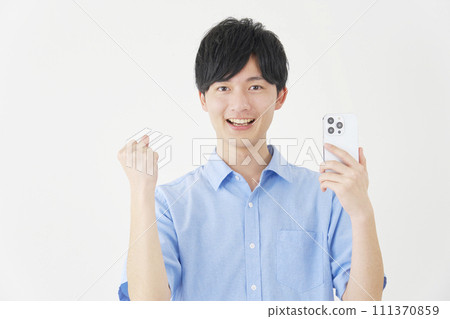 A man holding a smartphone and doing a fist pump, white background 111370859