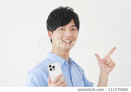A man holding a smartphone and signing a check, white background 111370860