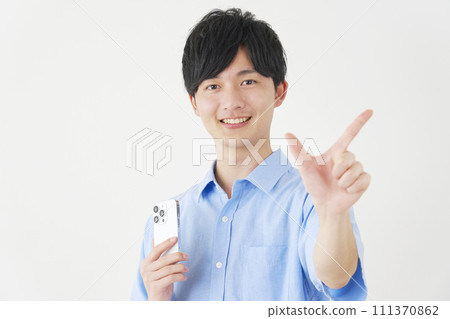 A man holding a smartphone and signing a check, white background 111370862