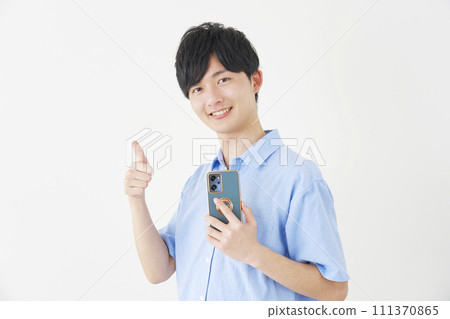 A man holding a smartphone and giving a good sign, white background 111370865