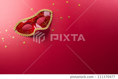 Happy Purim carnival decoration concept made from golden mask star and glitter on red background. (Happy Purim in Hebrew, jewish holiday celebrate) 111370977