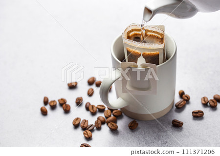 Drip coffee bag with ground coffee in  cup 111371206