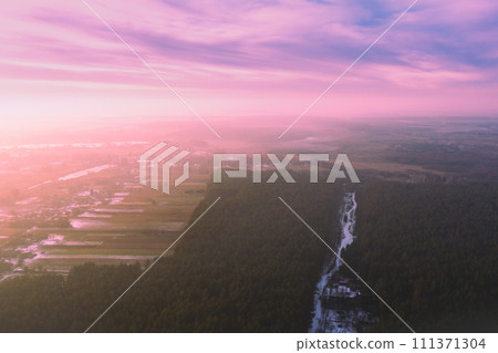 Rural landscape in winter, countryside with pine forest. Sunset over countryside. Aerial view 111371304
