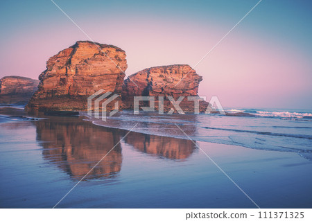 Seascape in the morning. Rocky sea coast at sunrise. Beach Playa de Las Catedrales in Ribadeo, Galicia, Spain, Europe Seascape in the morning. Rocky sea coast at sunrise. Beach Playa de Las Catedrales in Ribadeo, Galicia, Spain, Europe 111371325