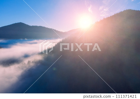 Fantastic view of the tops of mountain ridge above the clouds 111371421
