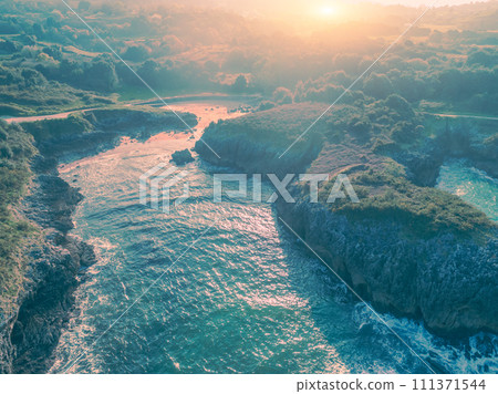 Aerial view of the rocky sea coast in the morning. The coast near the city of Buelna, Asturias, Spain 111371544