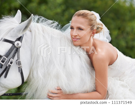 Wedding, woman and riding with horse in nature and happy for celebration, marriage and confidence in countryside. Bride, person and stallion on lawn in field with smile, dress and animal at ceremony 111371549