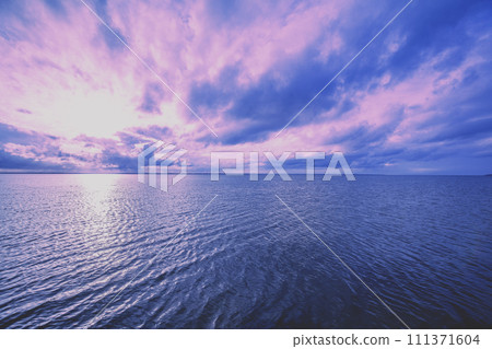 Early morning on the beach. Pink purple sunrise over the sea. Pastel color 111371604
