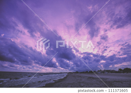 Early morning on the beach. Pink purple sunrise over the sea. Pastel color 111371605