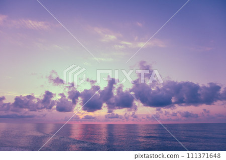 Early morning on the beach. Pink-purple dawn over the sea. Pastel color Early morning on the beach. Pink-purple dawn over the sea. Pastel color 111371648