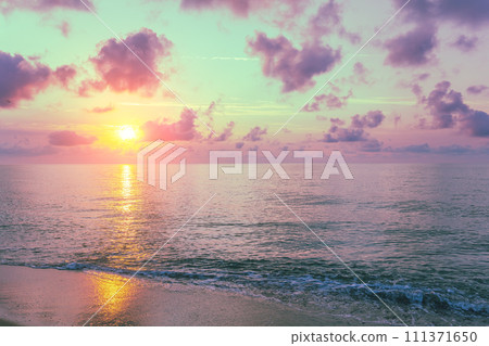 Early morning on the beach. Pink purple sunrise over the sea. Pastel color Early morning on the beach. Pink purple sunrise over the sea. Pastel color 111371650