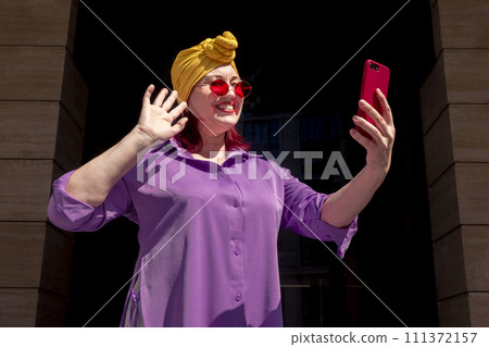 Happy adult asian with extravagant style with phone Happy adult asian with extravagant style with phone 111372157