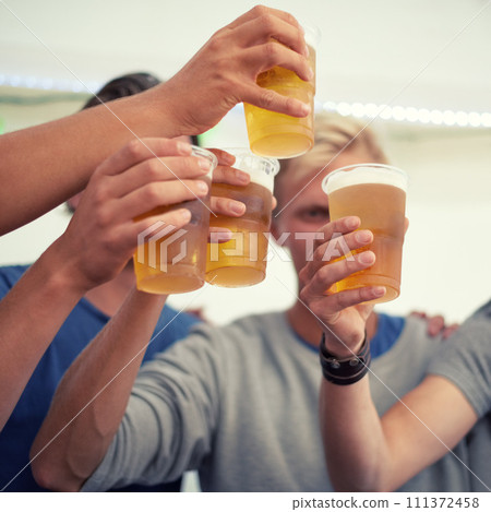 Hands, beer and group of friends cheers for party, celebration or adventure together. Fun, drinks and toast, men on vacation to relax and bonding with alcohol at holiday event at Munich festival. 111372458
