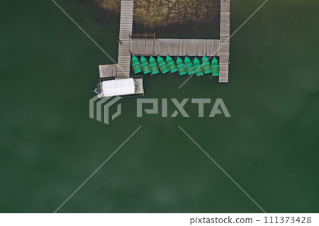 Aerial view of a lake boat dock. Flying above a vessel pier 111373428