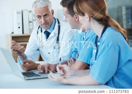 Laptop, meeting and doctor with nurses in hospital for medical diagnosis or treatment discussion. Team, computer and senior surgeon talking to healthcare workers for surgery research in clinic. 111373783