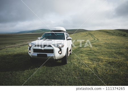 Tibet,China - June 13,2023 ,Driving Toyota off road car on the high altitude grassland mountains 111374265