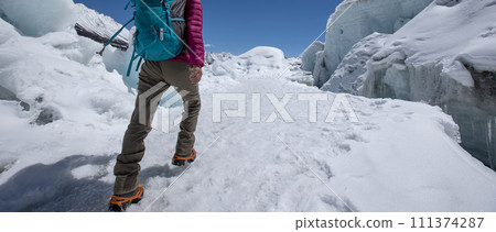 Woman hiker hiking in winter huge glacier mountain,China 111374287