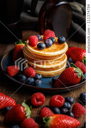 Homemade classic american pancakes with blueberries, raspberries and strawberries. 111374784