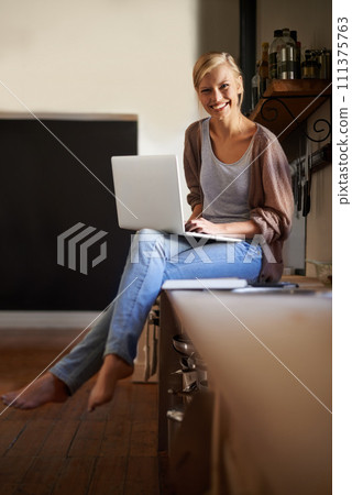 Woman in kitchen, laptop and remote work, smile in portrait and writer for blog, freelancer and copywriting. Working from home, website development and writing article, editor or journalist with tech Woman in kitchen, laptop and remote work, smile in portrait and writer for blog, freelancer and copywriting. Working from home, website development and writing article, editor or journalist with tech 111375763