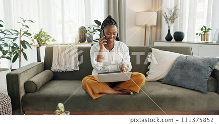 Black woman on sofa, phone call and laptop for remote work, social media or blog post research with smile in home. Happy girl on sofa with computer, cellphone and online chat in house for networking 111375852
