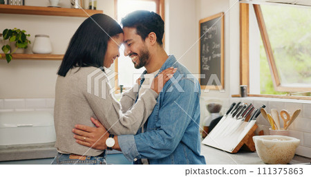 Love, hug and couple in a kitchen happy, together and intimate while bonding in their home. Embrace, romance and man with woman hugging, smile and sharing moment of trust, care or soulmate connection 111375863