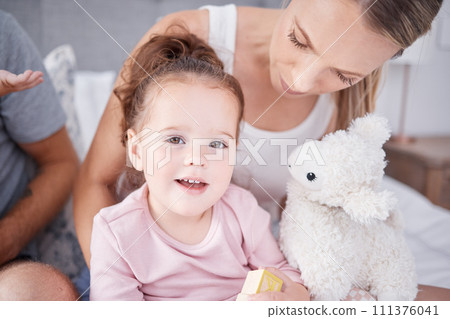 Face portrait of happy girl with mother, love and bonding in bedroom of home. Family, childhood and caring woman with little kid or child smiling, spending free time together and playing in the house 111376041