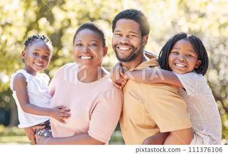 Children, family and love with a black man, woman and their kids outdoor in the park during summer. Happy, smile and parents with a mother, father and daughters as sister siblings outside together 111376106
