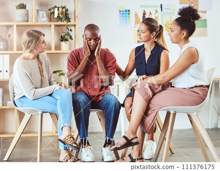 Community, mental health and support with group comfort colleague after bad news or fired at work. Care, unity and kindness by diverse people showing concern and love for depressed man in an office Community, mental health and support with group comfort colleague after bad news or fired at work. Care, unity and kindness by diverse people showing concern and love for depressed man in an office 111376175