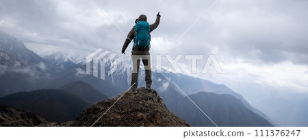 Woman hiker hiking at mountain top in tibet Woman hiker hiking at mountain top in tibet 111376247