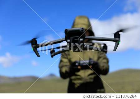Flying drone in high altitude mountains Flying drone in high altitude mountains 111376264