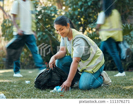 Volunteer, recycle pollution cleaning charity group working together to collect trash for sustainability. Community support, sustainable and eco friendly people help to clean park grass outdoor 111376271