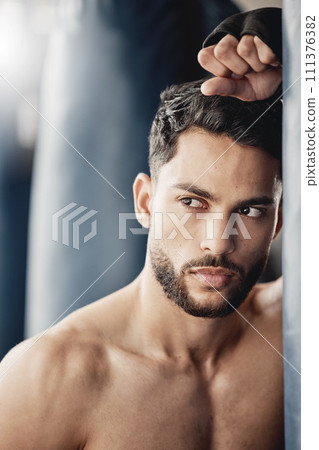 Fitness, exercise and boxing training by tough man boxer thinking and planning his strategy before a match. Young, athletic and handsome Mexican looking cool and serious, ready for physical challenge Fitness, exercise and boxing training by tough man boxer thinking and planning his strategy before a match. Young, athletic and handsome Mexican looking cool and serious, ready for physical challenge 111376382