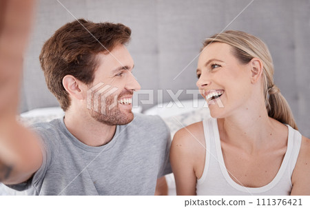 Couple selfie, happy love and relax in bedroom in home, smile for marriage and live streaming on social media together in house. Influencer man and woman with photo for internet online on holiday 111376421
