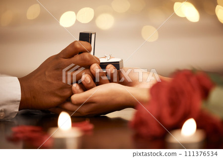 Ring, love and marriage proposal with couple on a romantic date and holding hands while asking the big engagement question. Commitment, anniversary and gift from a man to fiance woman to be engaged 111376534