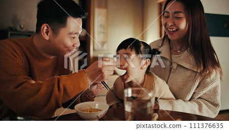 Food, home and Japanese parents and child at table for lunch, breakfast and eating meal together. Happy family, culture and mother, father and young girl in house for bonding, relationship and love Food, home and Japanese parents and child at table for lunch, breakfast and eating meal together. Happy family, culture and mother, father and young girl in house for bonding, relationship and love 111376635