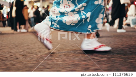 Japanese woman, feet and walking in kimono in city, journey and wellness for heritage on road. Person, blur or traditional clothes in tokyo street on holiday or sandals for travel in japan fashion 111376639