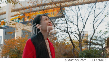 Japanese woman, thinking and outdoor in city for travel by train in autumn with trees and happiness. Park, nature and person in Tokyo forest on commute in morning on subway metro transportation 111376815