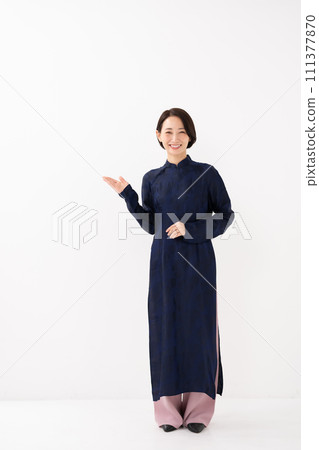 A woman wearing Ao Dai, holding her hand 111377870