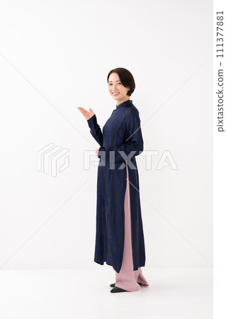 A woman wearing Ao Dai, holding her hand 111377881