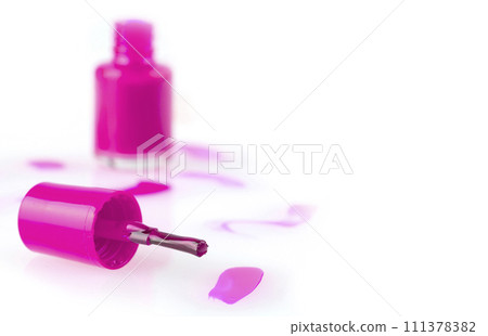 Close up of the pink nail polish bottle and drop on white background Close up of the pink nail polish bottle and drop on white background 111378382