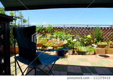 Relax on an outdoor chair on the roof balcony of your condominium for a luxurious summer time 111378410