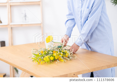 Ikebana flower arrangement on hand 111378606