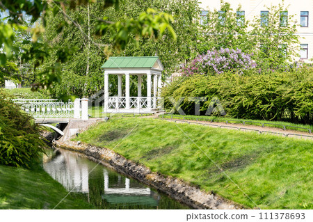 Polish garden at the Derzhavin estate. Gorgeous spring bloom. Pond, bridge Polish garden at the Derzhavin estate. Gorgeous spring bloom. Pond, bridge 111378693