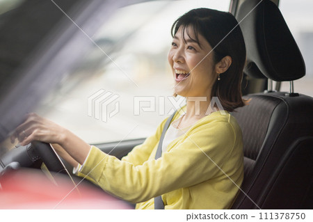 A woman driving a minivan A woman driving a minivan 111378750